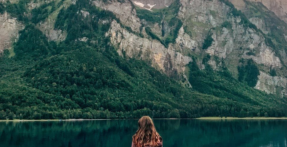 woman standing on brown wooden plank