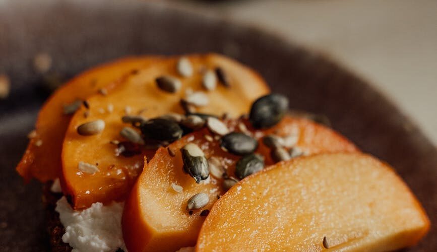 brown and black pastry on black round plate