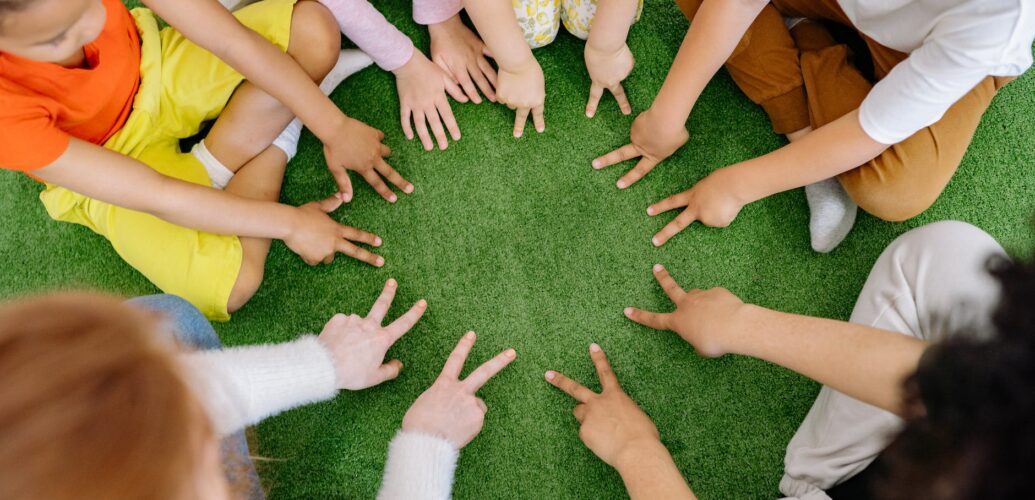 group of children playing on green grass