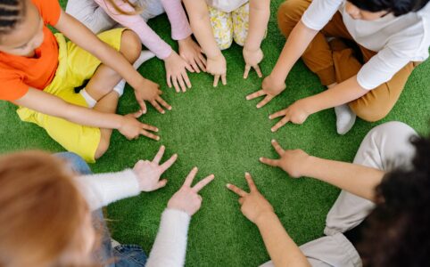 group of children playing on green grass