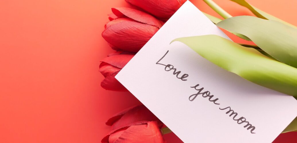 photo of a card with text on red tulips