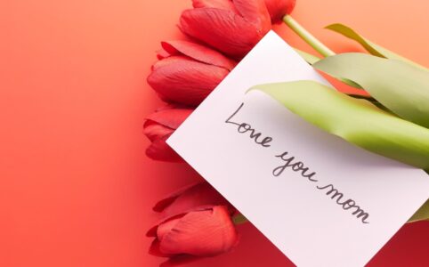 photo of a card with text on red tulips