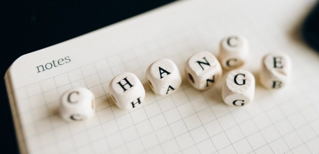 a close up shot of letter dice on an open notebook