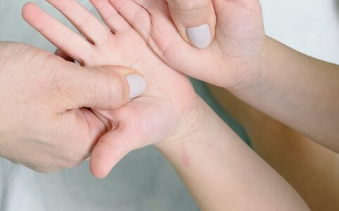 close up shot of person touching a child s hands