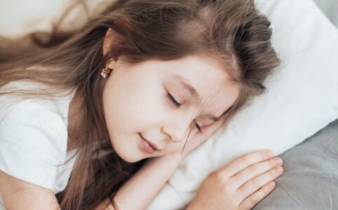 brunette girl sleeping on a pillow