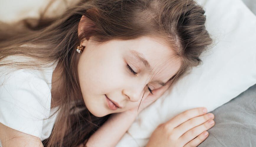 brunette girl sleeping on a pillow