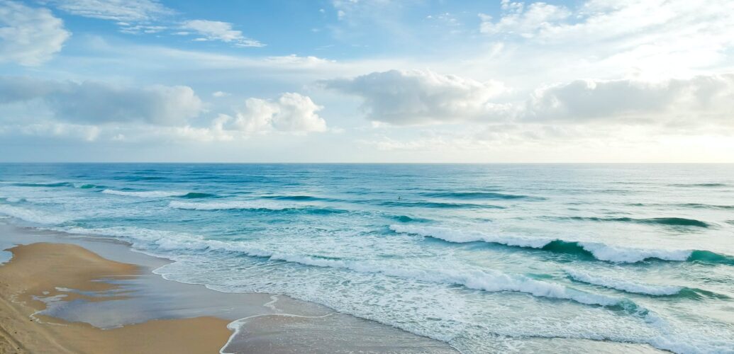 beach under blue and white sky