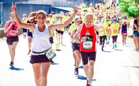 female and male runners on a marathon