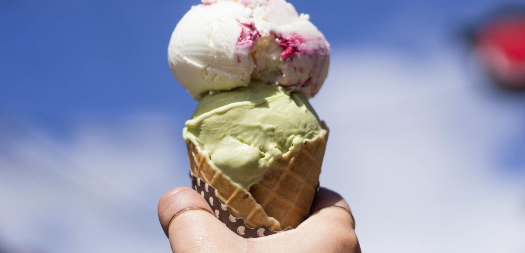 person holding ice cream with cone