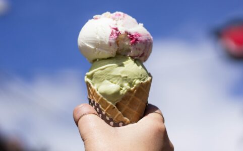 person holding ice cream with cone