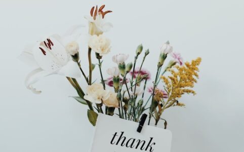 bunch of flowers with a postcard