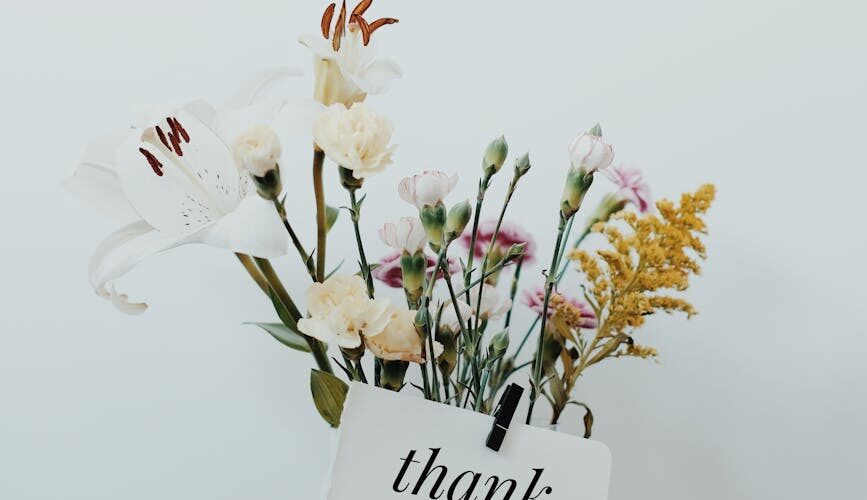 bunch of flowers with a postcard